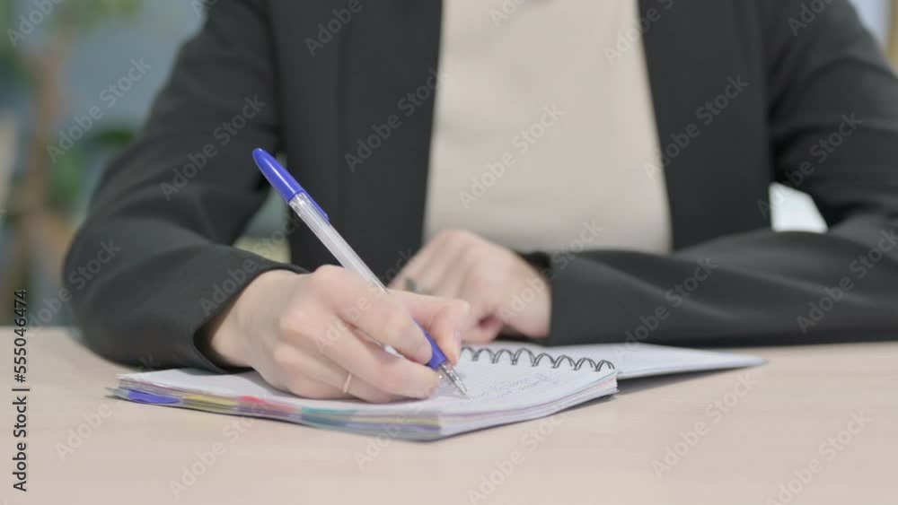 Close up of Businesswoman Writing in Office Close up of Businesswoman Writing in Office