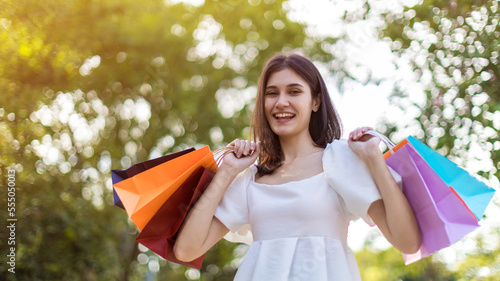 Beautiful girl holding shopping bags. Women are shopping In the summer she is using a credit card and enjoys shopping.