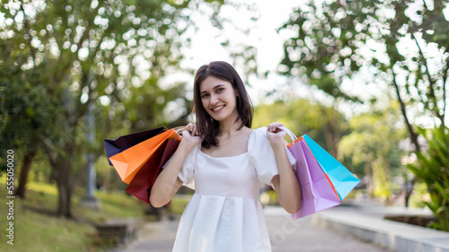 Beautiful girl holding shopping bags. Women are shopping In the summer she is using a credit card and enjoys shopping.