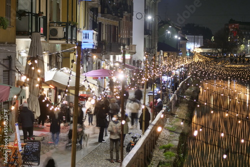 View of the crowded Naviglio Grande district in Milan and christmas lights.