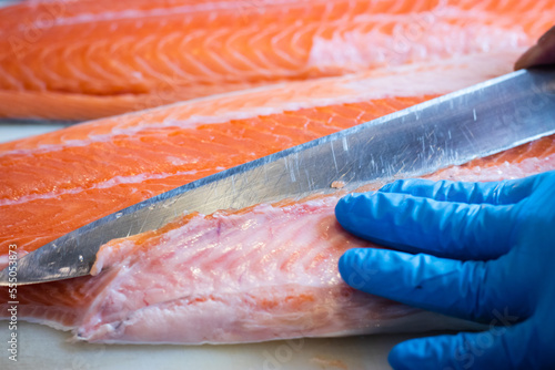 Japanese chefs filleting salmon, a delicate professional skill to make the most of the fillets.