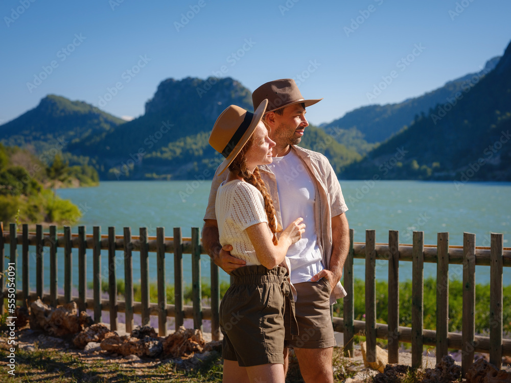 Travelers couple look at mountain lake. Love and Travel happy emotions Lifestyle concept. Young family traveling active adventure vacations. Adventure and travel in mountains region in Turkey