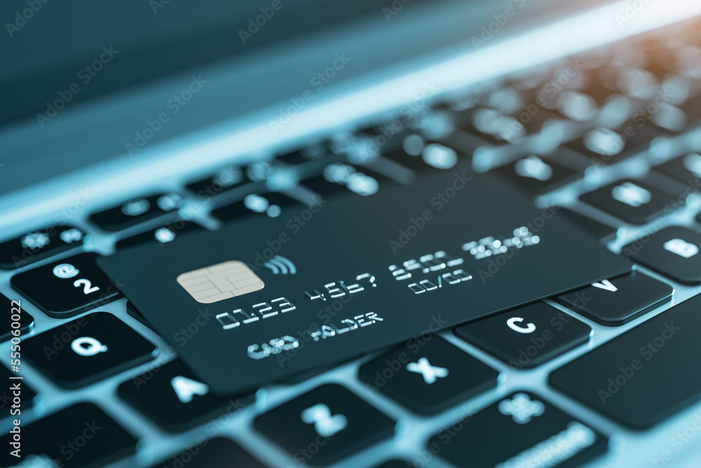 Online shopping and online purchase concept with perspective view on black credit card on modern laptop keyboard background, close up. 3D rendering Online shopping and online purchase concept with perspective view on black credit card on modern laptop keyboard background, close up. 3D rendering