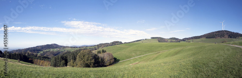 Panoramic view of landscapes around Gersbach in Black Forest. Wind turbines on top of green hills surrounded by dense forests