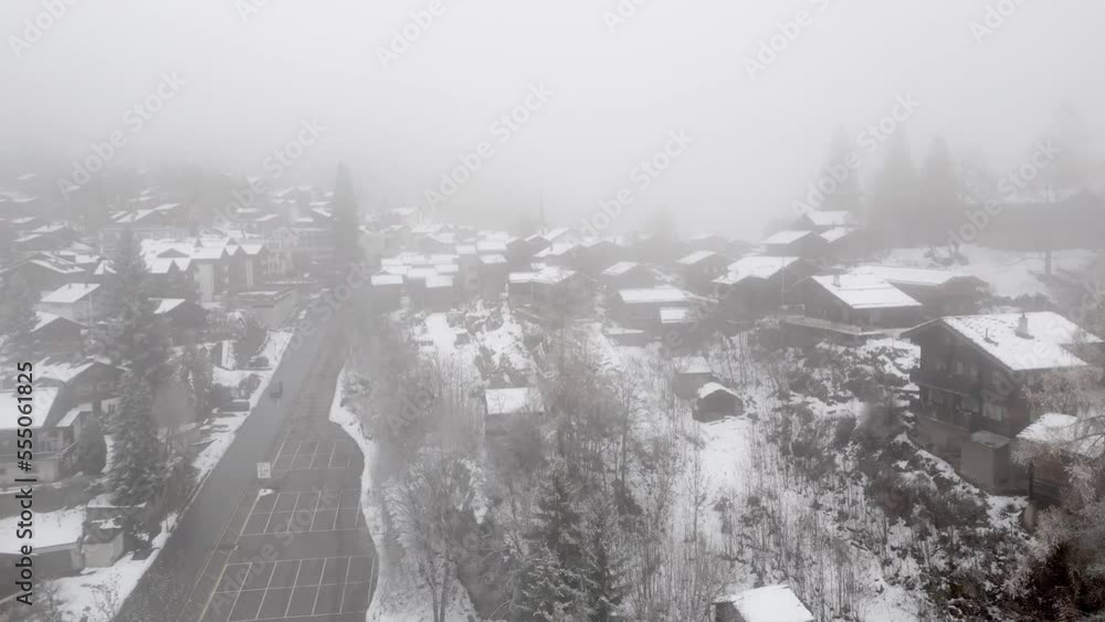 Swiss mountain village Blatten Belalp with stables and chalets in fog and snow. Snowy landscape with snowy cottages in Swiss Alps. Swiss mountain village Blatten Belalp with stables and chalets in fog and snow. Snowy landscape with snowy cottages in Swiss Alps.
