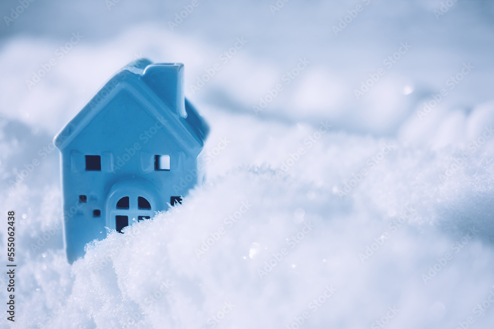 Blue monday concept with small house on cold winter snow background. Blue Monday in January the most depressing day of the year. Sad, loneliness, depression concept Blue monday concept with small house on cold winter snow background. Blue Monday in January the most depressing day of the year. Sad, loneliness, depression concept