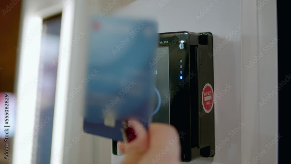 Woman Gentle Hand Placing Her Payment Car On Suspended Payment Machine Woman Gentle Hand Placing Her Payment Car On Suspended Payment Machine