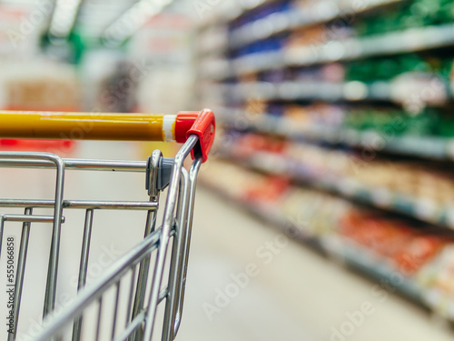 shopping trolley in supermarket aisle, copy space