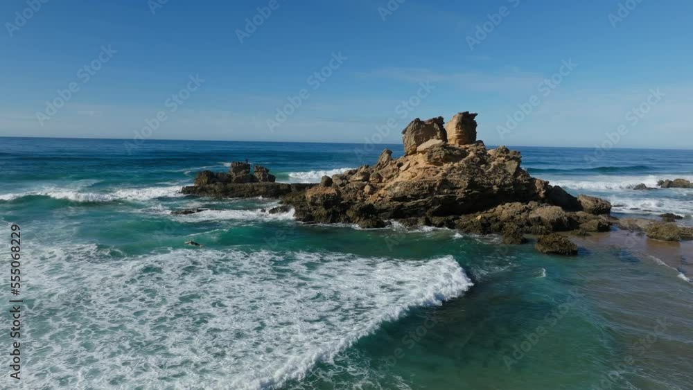 Algarve, Portugal, Europe. Scenic rocks in deep blue ocean, drone orbit Algarve, Portugal, Europe. Scenic rocks in deep blue ocean, drone orbit