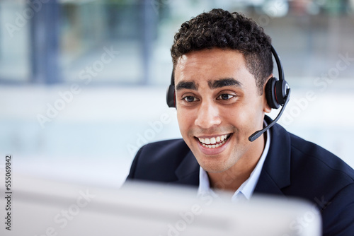 Businessman, computer or call center in telemarketing help company, customer support office or b2b sales CRM. Smile, happy or talking receptionist worker with technology headset in Indian contact us