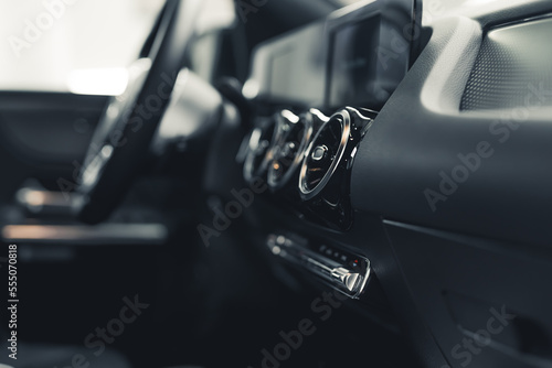 Close up of interior of car dashboard ventilation control and steering wheel. Car detailing, Horizontal shot. High quality photo