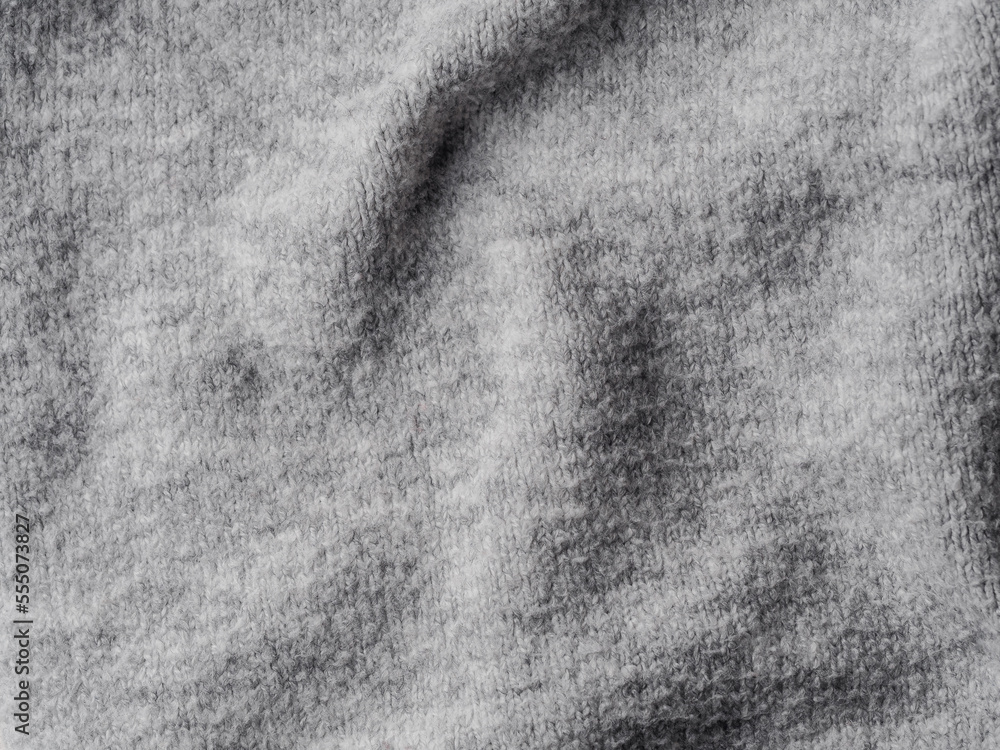 Fototapeta premium Gray sweater fabric texture. Clothes sweater background with folds