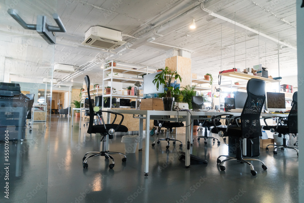 Shot of an industrial looking working space with multiple empty seats . Shot of an industrial looking working space with multiple empty seats .