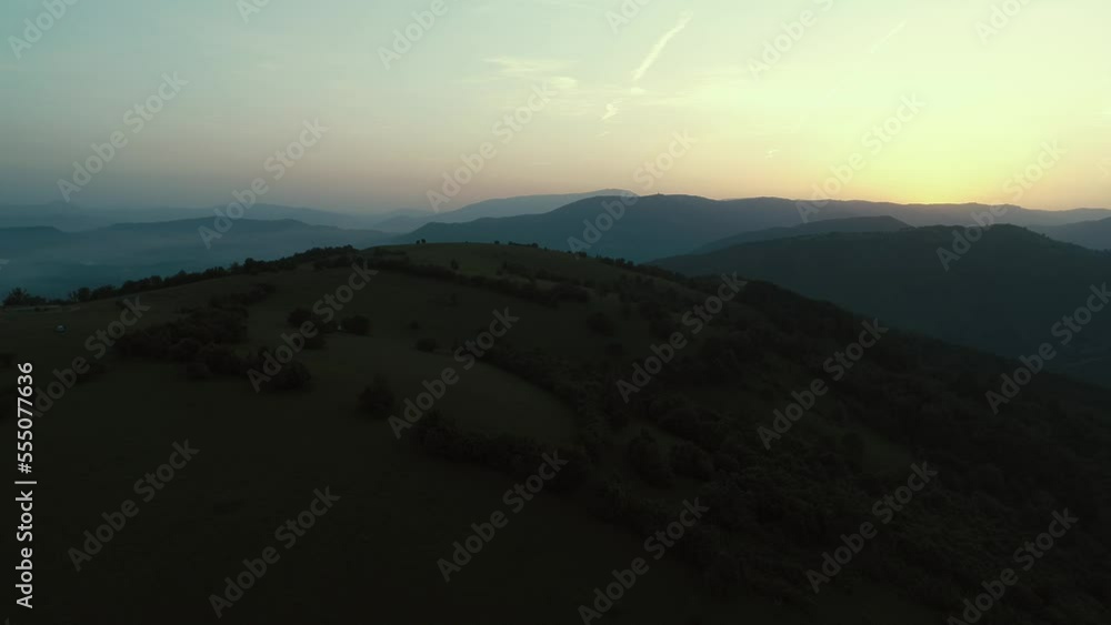 Cinematic aerial shot of an endless mountain and forest landscape. Flight over hills forest in Mountain at sunset. Cinematic aerial shot of an endless mountain and forest landscape. Flight over hills forest in Mountain at sunset.
