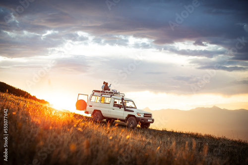 Fototapeta People watching sunset on top of 4x4 vehicle in Mountains of Goden, Kosovo