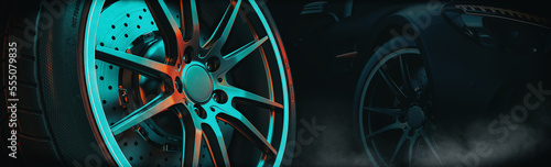 Close up car alloy wheel. side black car background