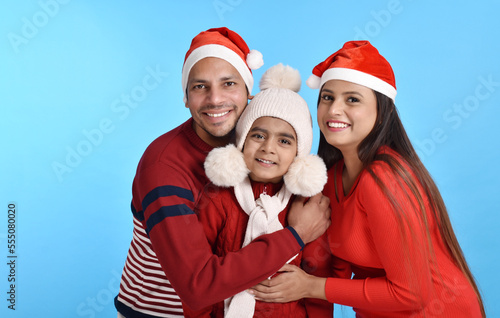 Young Happy Indian family celebrating Christmas 