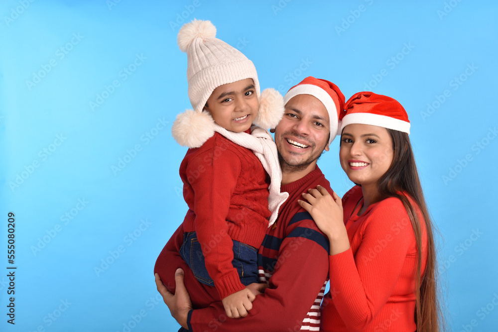 Young Happy Indian family celebrating Christmas Young Happy Indian family celebrating Christmas
