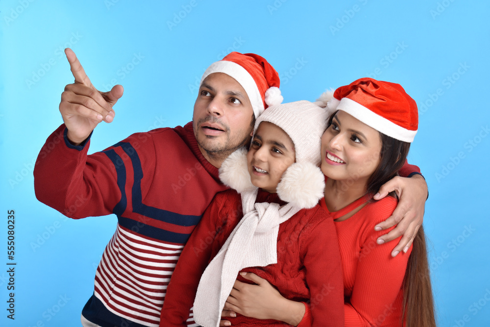 Young Happy Indian family celebrating Christmas Young Happy Indian family celebrating Christmas