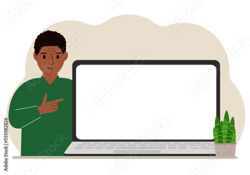 A man next to a large laptop with plenty of space for text.