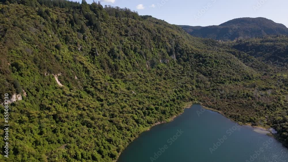 Incredible aerial dolly in showing view of the lush dense forest surrounding Lake Tarawera, New Zealand. Incredible aerial dolly in showing view of the lush dense forest surrounding Lake Tarawera, New Zealand.