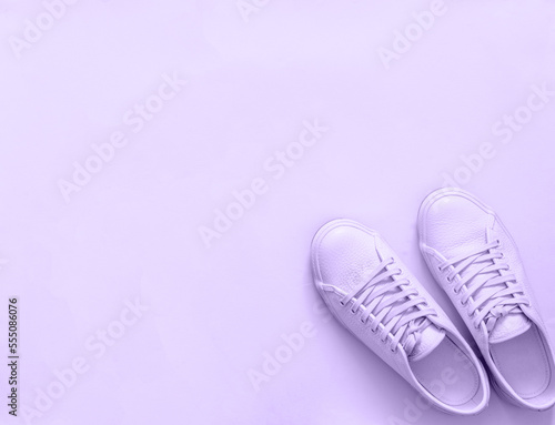 violet sneakers on violet background, copy space