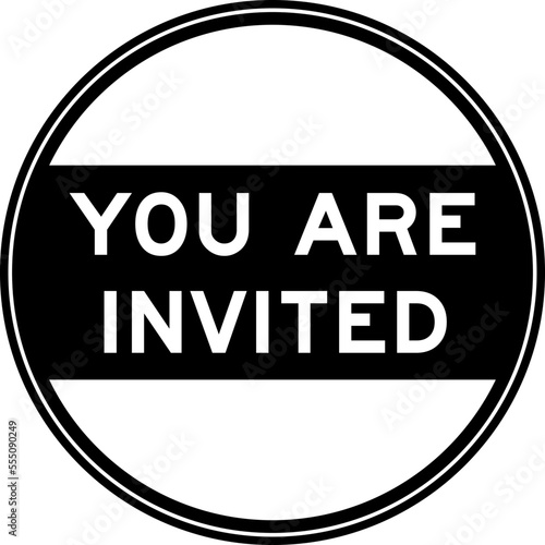 Black color round seal sticker in word you are invited on white background