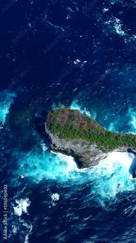 Vertical aerial video of bay with turquoise water and rocky islands with few bushes Vertical aerial video of bay with turquoise water and rocky islands with few bushes