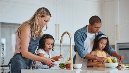Tableau sur toile Family, mother and father with girls in kitchen, rinse vegetables and bonding
