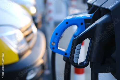 close-up of black and blue adapter with electric vehicle cables, replenish battery charging station, alternative energy development concept, electric vehicle production, electric energy storage