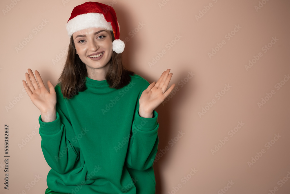 Merry young woman wear xmas sweater Santa hat posing do winner gesture celebrate clenching fists say yes isolated on plain pastel light green background Happy New Year 2023 celebration holiday concept Merry young woman wear xmas sweater Santa hat posing do winner gesture celebrate clenching fists say yes isolated on plain pastel light green background Happy New Year 2023 celebration holiday concept