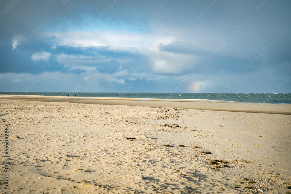 the sand on the beach and sky and Horizon in the background