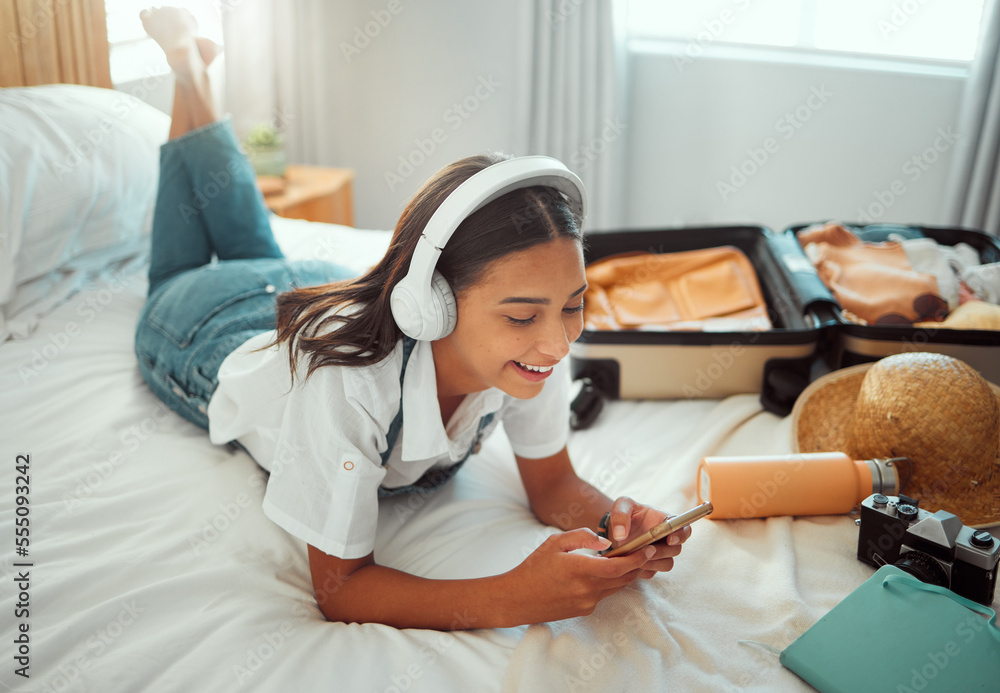 Obraz premium Social media, music and woman with phone on a holiday, travel communication and mobile app update. Podcast, internet and girl in a bedroom for freedom on vacation, streaming radio and typing on chat