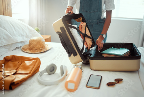 Suitcase, woman and packing clothes, bag and luggage for travel, vacation and international journey, summer adventure and tourism. Closeup female tourist, hotel room and holiday clothing in baggage photo