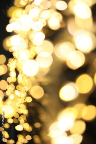 Golden blurred lights on black background. Bokeh effect