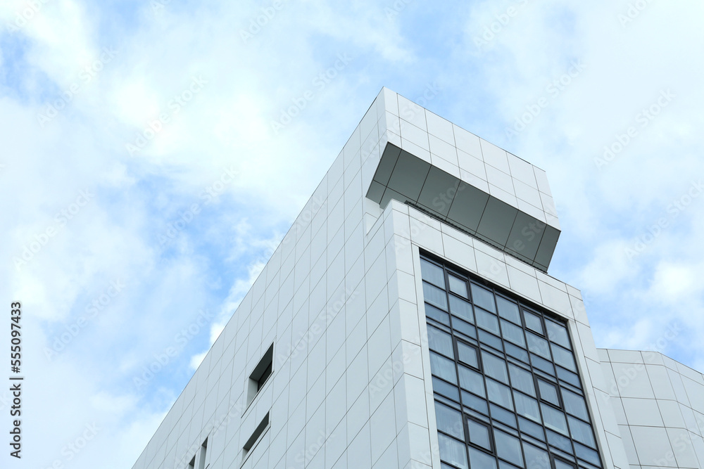 Modern office building against sky with clouds Modern office building against sky with clouds