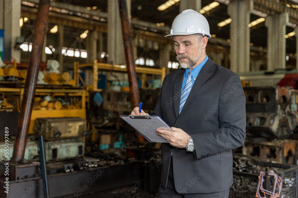A businessman checks on-site maintenance work at an old factory for train rehearsals... A businessman checks on-site maintenance work at an old factory for train rehearsals...