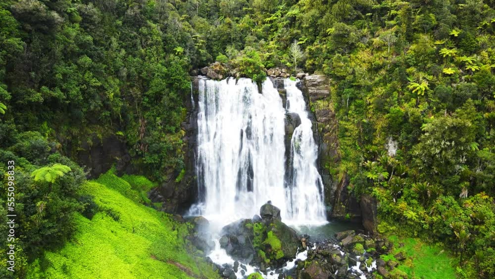 Drone slowly moving towards a waterfall at high rocky cliff. 4K videos. Drone slowly moving towards a waterfall at high rocky cliff. 4K videos.