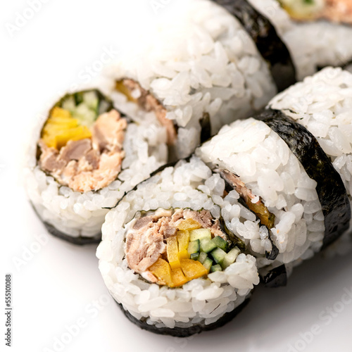 Sushi rolls uramaki with cucumber, tuna, yellow pepper. Healthy and useful feed. Set of rolls. Isolate on white background. Soft focus. View from above.