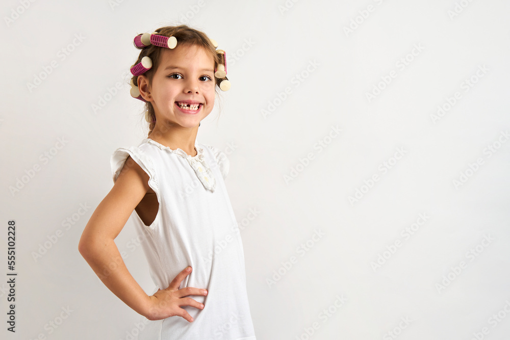Little girl with curlers on white background Little girl with curlers on white background
