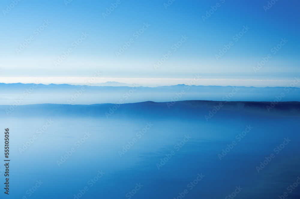 A horizon of blue mountains at dawn