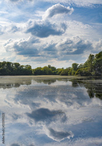 Cloudy sky refelcted in placid Northamptonshire lake photo