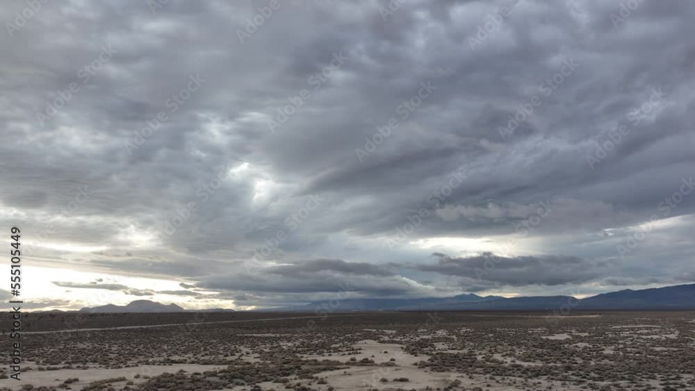 Dark, ominous clouds gather above the flat landscape of the Mojave Desert - aerial hyper lapse Dark, ominous clouds gather above the flat landscape of the Mojave Desert - aerial hyper lapse