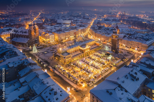 Snow covered old town in Krakow with a view of the Christmas Market photographed in the blue hour. © PawelUchorczak