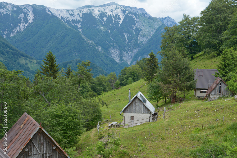 Old tiny shepherd's houses in Slovenia Julian Alps. Summer shelters for cow shepherds surrounded by pastures and mountains. 