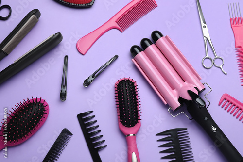 Fototapeta Naklejka Na Ścianę i Meble -  Flat lay composition of different professional hairdresser tools on lilac background