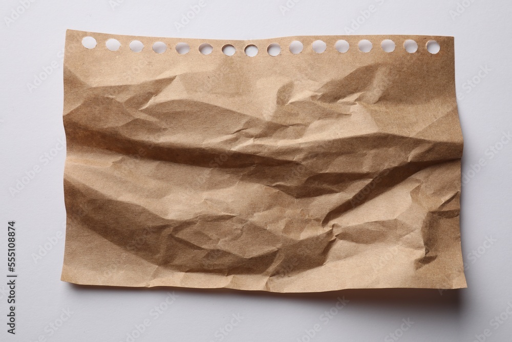 Crumpled sheet of paper on white background, top view Crumpled sheet of paper on white background, top view
