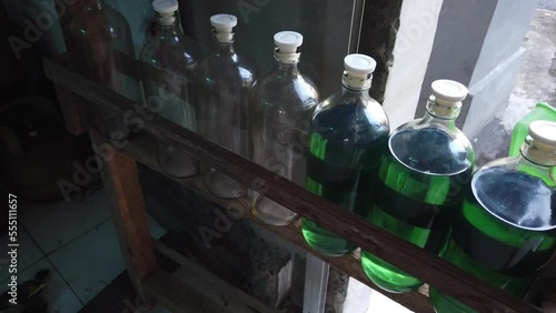 Gas Petrol Station in Asia, Blue Oil Stored in Glass Bottles, Indonesia Bali Southeast Asian Typical Shop photo