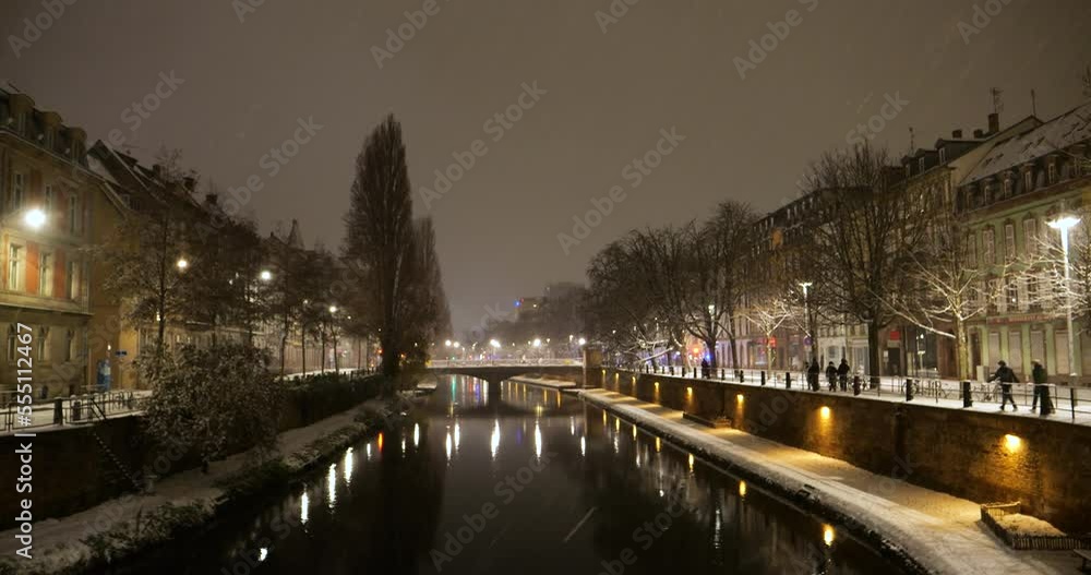 Aerial view of winter Strasbourg at evening dawn, snowed natural parkland, Ill river and high-rise residential districts on the background, with picturesque weather conditions Aerial view of winter Strasbourg at evening dawn, snowed natural parkland, Ill river and high-rise residential districts on the background, with picturesque weather conditions