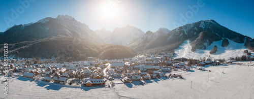 Kranjska Gora in Slovenia covered in snow at winter with Julian Alps and Triglav National Park in the background. Aerial Panorama